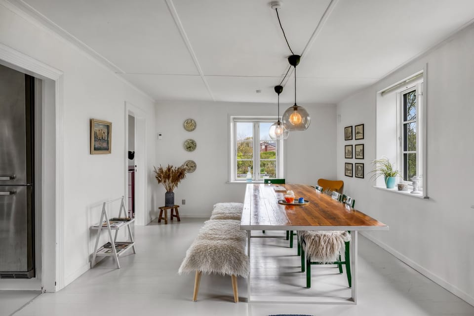 A bright dining area with sheepskin benches and large windows onto the marsh.